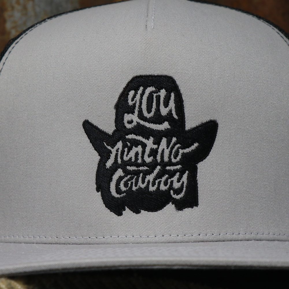 You Ain't No Cowboy Silhouette Silver and Black Mesh Flatbill